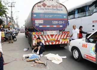 The victim of the road traffic accident lies prostrate next to the fuel tanker with which he collided on his motorcycle in Naklua, Thursday, March 30.